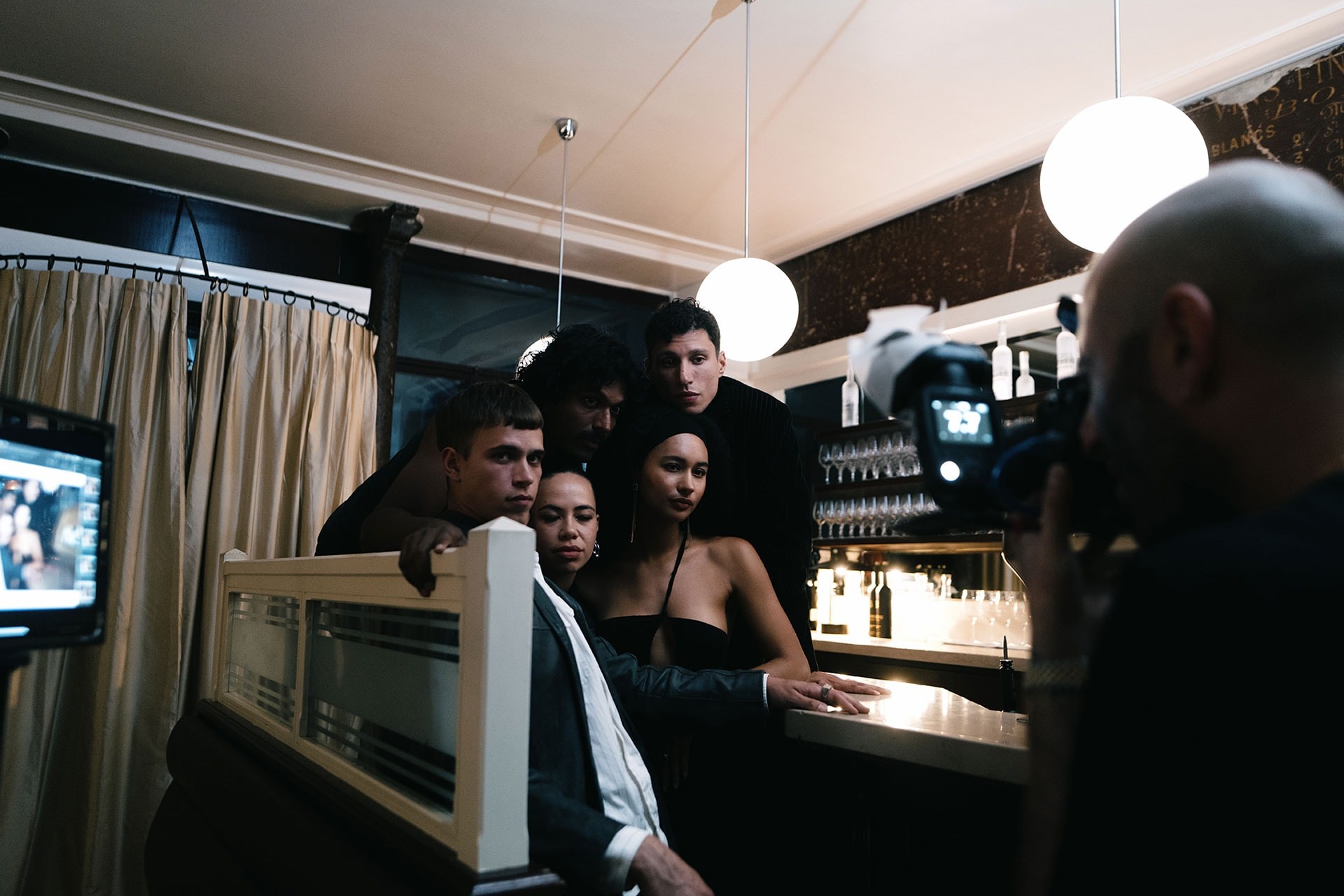 LP-Dirty-Brew-people posing for a photo in front of a bar with a Dirty Brew Bottle