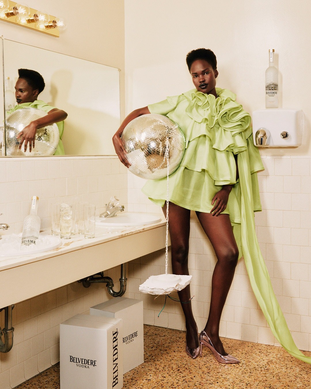 Belvedere and Tyler Mitchell - Womand in a bathroom holding a disco ball